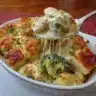 Delicious Million Dollar Chicken Casserole topped with cheese and herbs