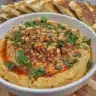 Bowl of muhammara, a Syrian dip made with roasted red peppers and walnuts