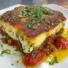 Servings of vibrant Greek moussaka, featuring layers of eggplant and meat sauce.