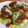 Salmon balls served with a creamy avocado sauce on a plate