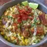 Street corn chicken rice bowl featuring grilled chicken and fresh ingredients.