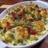 Baked vegetable casserole dish with fresh vegetables and herbs