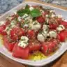 Quick watermelon feta salad with fresh ingredients on a white plate