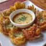 Crispy air fryer blooming onion served with dipping sauce