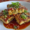 Crispy air fryer tofu with sticky sesame sauce drizzled on top