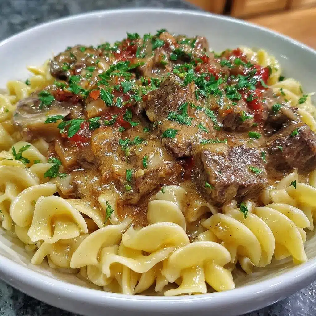 Delicious Beef Stroganoff served over egg noodles in creamy sauce