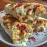 Cheesy garlic chicken wraps filled with melted cheese and garlic flavor.