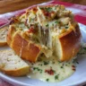 Chicken Alfredo Garlic Bread Bowls served hot in a rustic wooden bowl