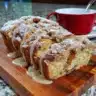 Loaf of homemade Cinnamon Rhubarb Bread cooling on a rack