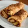 Crispy apple pie roll-ups with a golden brown crust and cinnamon topping