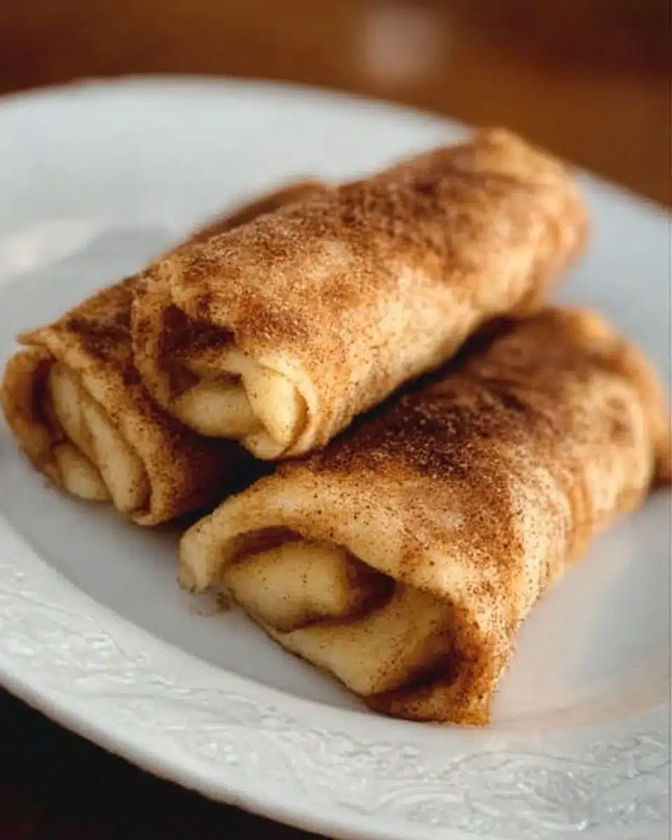 Crispy apple pie roll-ups with a golden brown crust and cinnamon topping