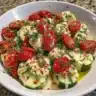 Fresh Cucumber Caprese Salad with mozzarella and basil on a plate