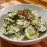 Fresh Cucumber Dill Salad with herbs and dressing in a bowl