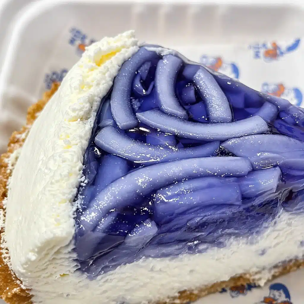Sliced butterfly pea jelly pie with airy layers of creamy coconut filling at Chim Chim NYC.