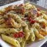 Plate of delicious Crack Chicken Penne with creamy sauce and garnishes