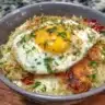 A delicious serving of Egg Biryani garnished with herbs and spices.