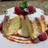 Fluffy air fryer vanilla cake topped with fresh fruit and frosting