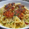Delicious Garlic Butter Chicken served with bowtie pasta and fresh herbs