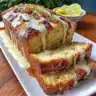 Freshly baked Lemon Rhubarb Loaf with bright lemon glaze and rhubarb slices