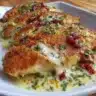 Baked Caesar Chicken served with creamy parmesan sauce on a plate