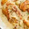 Chicken breasts cooked in a creamy garlic sauce garnished with herbs