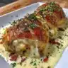 Delicious Chicken Wellington with Dijon cream sauce on a serving plate