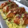 Plate of Pretzel Chicken topped with mustard-cheddar sauce.
