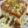 Cheesy ground beef and rice casserole served in a baking dish