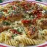 Delicious creamy Cajun chicken pasta garnished with herbs and served in a bowl