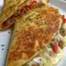Delicious ground beef quesadillas with a crispy golden-brown crust on a plate.