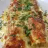 Indulgent queso chicken enchiladas served on a plate