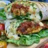 Keto Cheesy Garlic Chicken Wraps served on a plate with fresh herbs