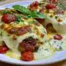 Keto Chicken Parmesan served with fresh basil and cheese on a white plate