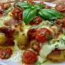 Keto Chicken Parmesan Casserole served in a dish, garnished with fresh herbs.