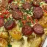 Kielbasa sausage cheesy potato casserole served in a baking dish