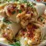 Low carb cheesy garlic chicken wraps on a plate garnished with herbs