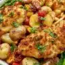 Oven-baked Parmesan Crusted Chicken with vegetables on a sheet pan
