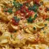 Creamy spicy buffalo chicken pasta garnished with herbs in a bowl