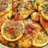 Delicious Lemon Pepper Chicken garnished with lemon slices and peppercorns.