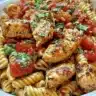 Delicious Bruschetta Chicken Pasta plated with fresh basil and tomatoes