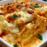 Cheesy Buffalo Ranch Chicken Lasagna served in a dish with fresh herbs.