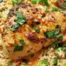 Plate of Coconut Lime Chicken served with rice and fresh lime wedges