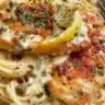Creamy Lemon Chicken Piccata served with pasta and lemon slices