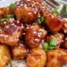 Healthy sesame chicken served with vegetables on a plate