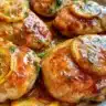 Delicious lemon dill chicken served on a plate with fresh herbs.