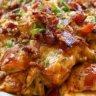 Keto BBQ Chicken Casserole in a dish, topped with cheese and herbs