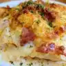 Keto Chicken Cordon Bleu Casserole topped with cheese and ham