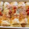 Low carb white chicken enchiladas served on a plate with toppings