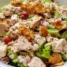 Delicious rotisserie chicken salad in a bowl, fresh ingredients and vibrant colors.