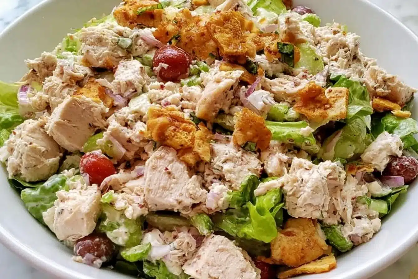 Delicious rotisserie chicken salad in a bowl, fresh ingredients and vibrant colors.